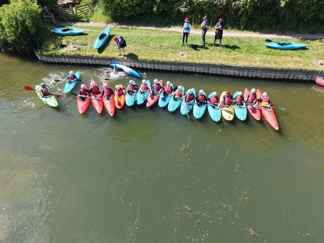 Explorer Scouts kayaking through spray