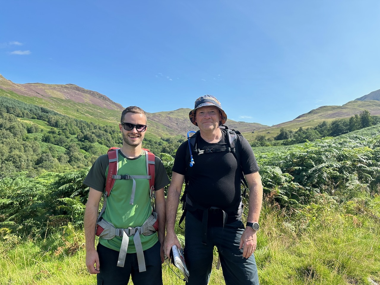 Scouts hiking across a mountain landscape
